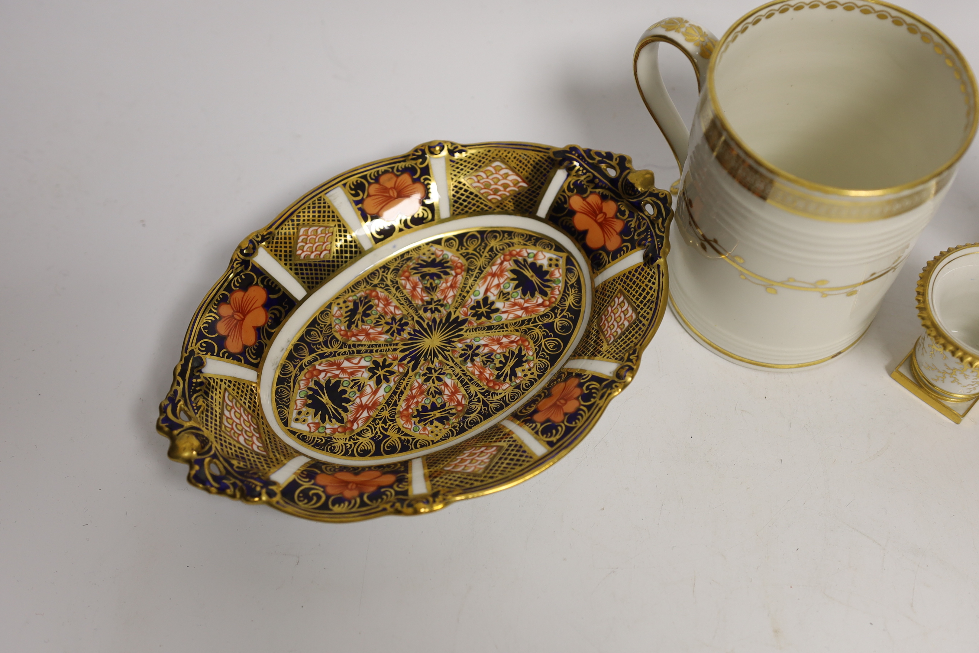 Four porcelain items - a small Flight Barr & Barr Worcester she’ll painted vase, a Derby mug, a Royal Crown Derby dish and a Sitzendorf figure, 16cm